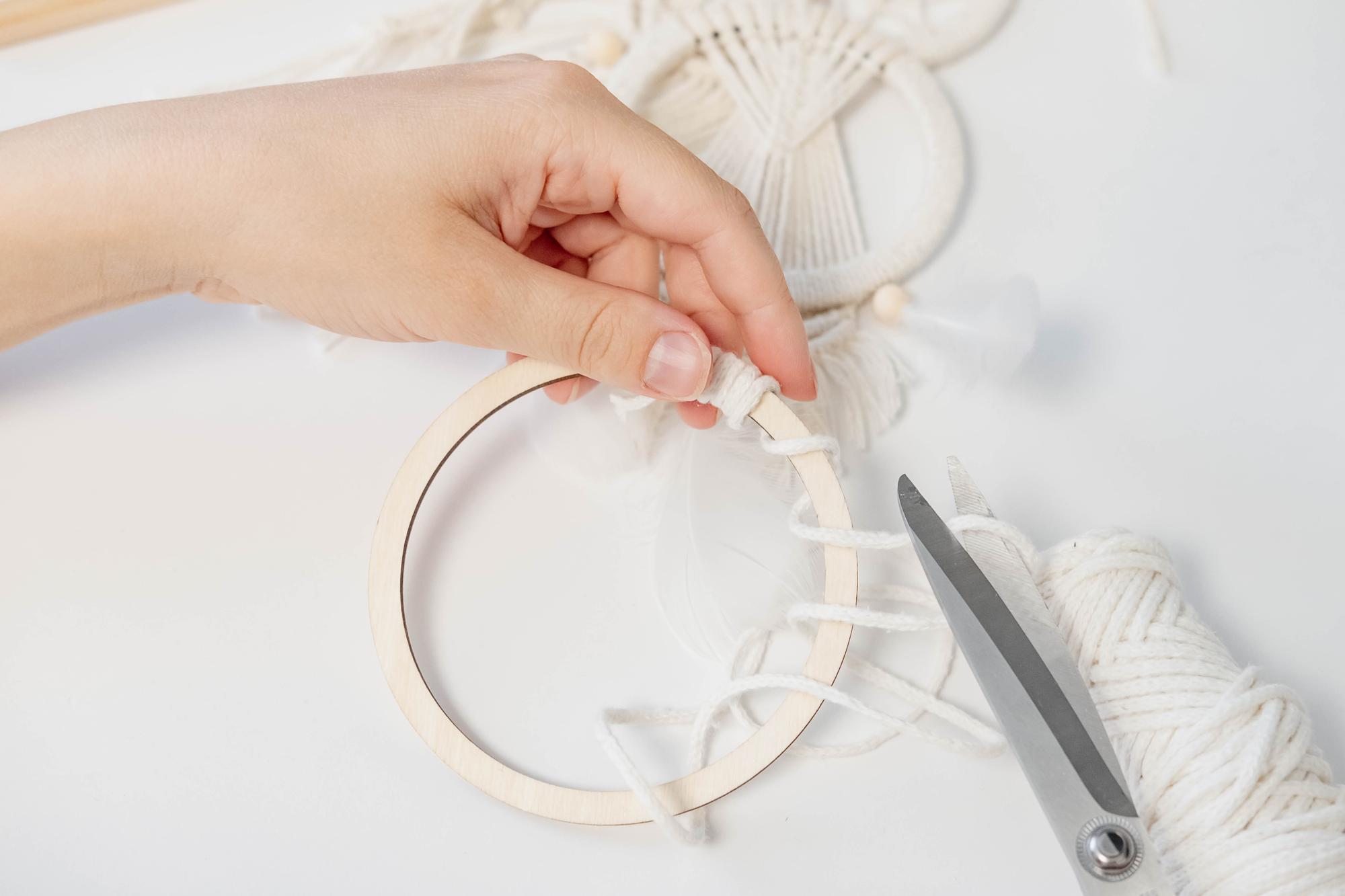artisan stitching floral motif on hoop