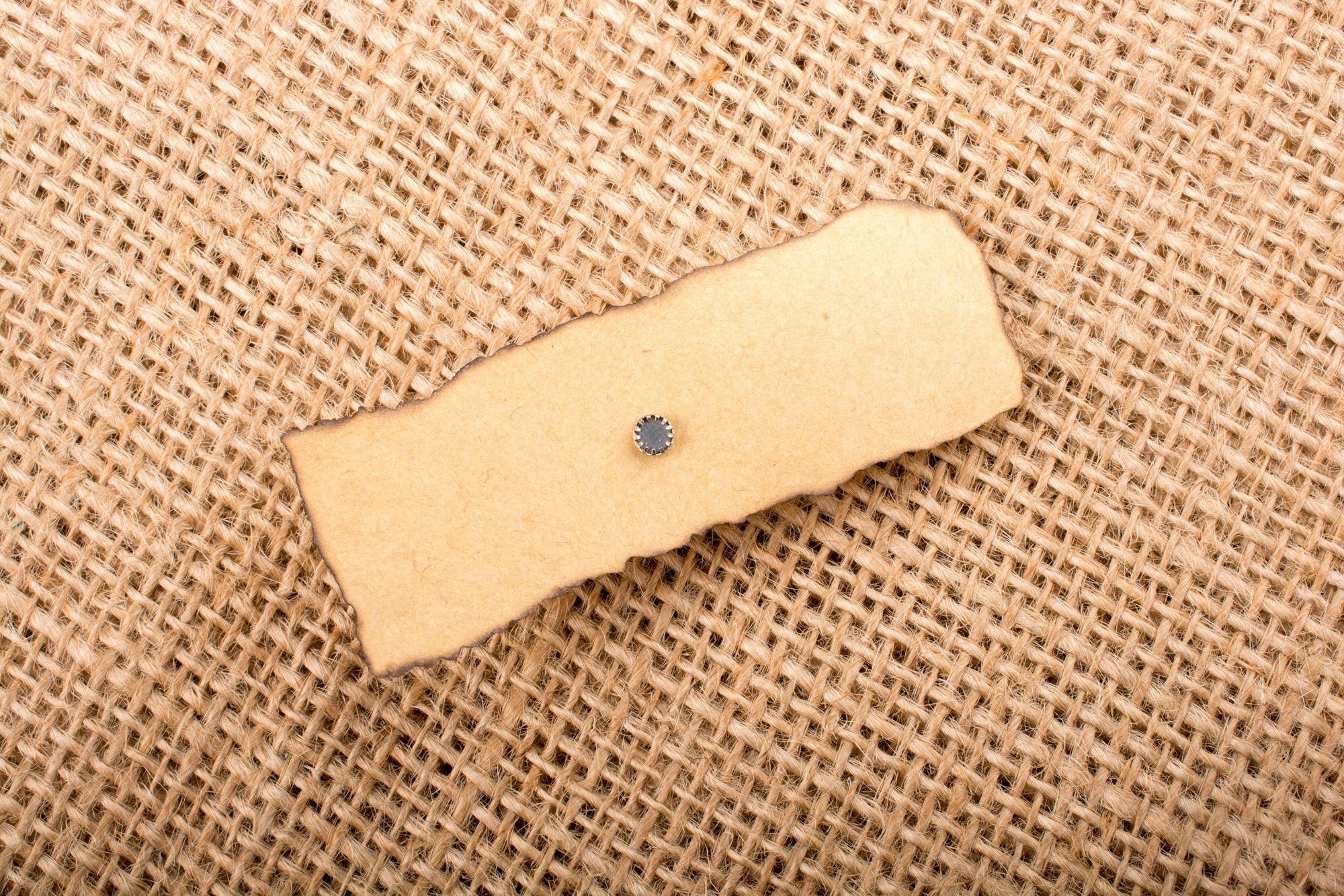 three embroidered patches on kraft